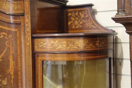 An Edwardian marquetry inlaid bowfronted china display cabinet, in the manner of Edwards & Roberts, H.6ft 6in. W.5ft 4in.